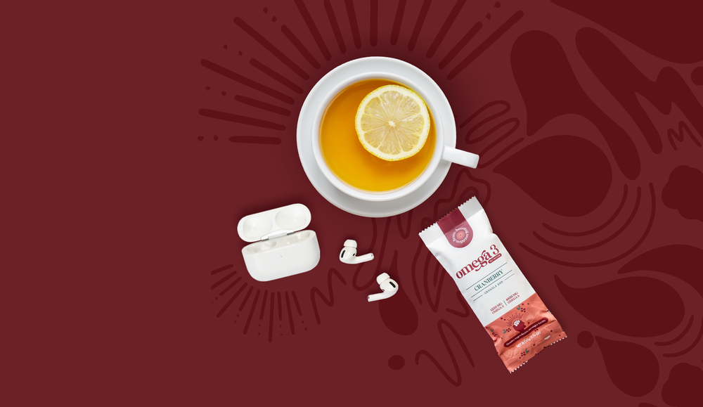 Omega 3 cranberry granola bar with a cup of tea, lemon and air pods